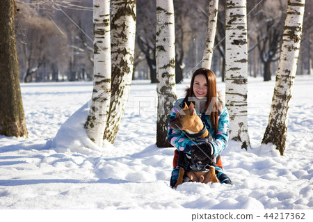 Adorable girl with her dog walks in park 44217362