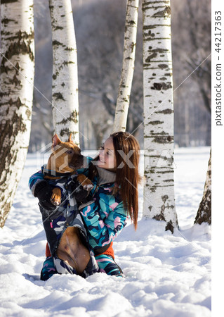 Adorable girl with her dog walks in park 44217363