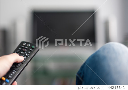 Hand with TV remote control 44217841