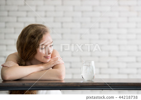 Young woman in joyful postures with jug and glass Young woman in joyful postures with jug and glass 44218738