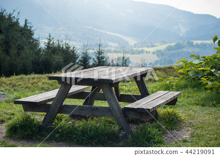 wooden picnic table in mountain landscape wooden picnic table in mountain landscape 44219091