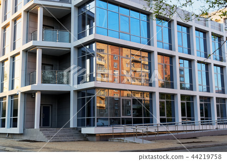 Old apartment building reflecting in glass facade 44219758