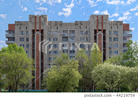 Old apartment house against cloudy blue sky 44219759