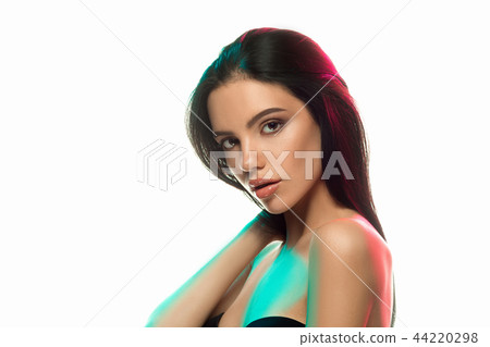 High Fashion model woman in colorful bright lights posing in studio 44220298