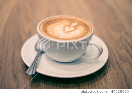 Latte art coffee on the wood table. Latte art coffee on the wood table. 44220993