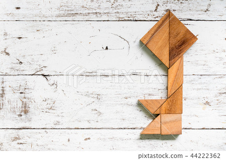 Tangram puzzle in key shape on white wood 44222362
