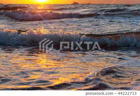 beautiful sunrise and waves on the sea beautiful sunrise and waves on the sea 44222713