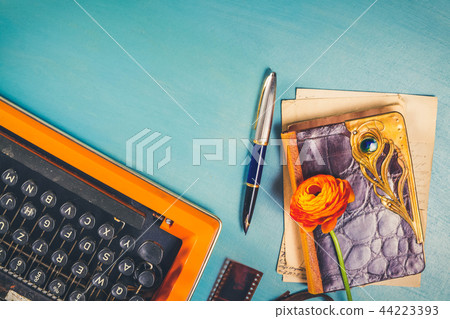 Workspace with vintage orange typewriter Workspace with vintage orange typewriter 44223393
