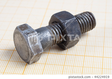 Screw and Nuts on graph paper background 44224919