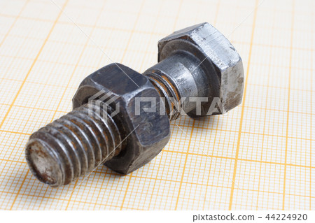 Screw and Nuts on graph paper background 44224920