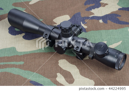 sniper scope on camouflaged background 44224995