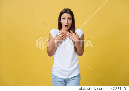 Beautiful female half-length portrait isolated on yellow studio backgroud. The young emotional Beautiful female half-length portrait isolated on yellow studio backgroud. The young emotional 44227143