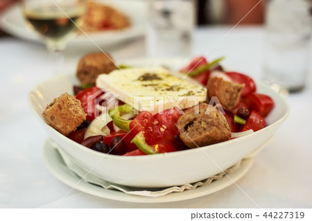 greek salad on plate and feta cheese on top 44227319