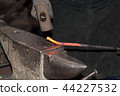 Making the horseshoe from heated red rod 44227532