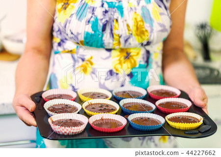 Woman with a muffins tray Woman with a muffins tray 44227662