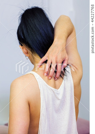 Woman scratching back Woman scratching back 44227768