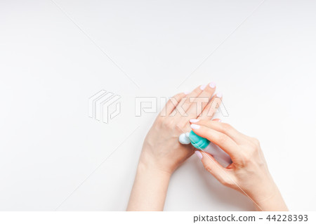 Woman moisturizing her hands with foam lotion Woman moisturizing her hands with foam lotion 44228393