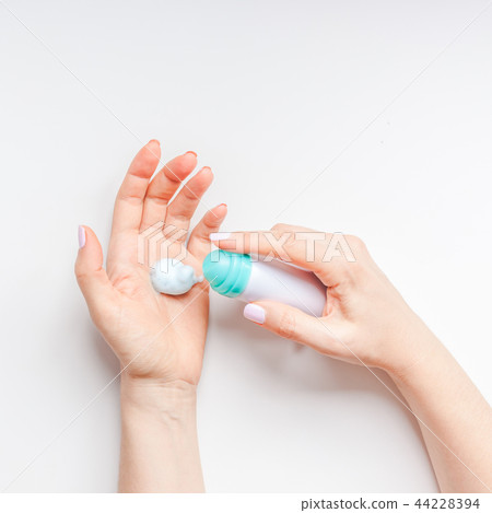 Woman moisturizing her hands with foam lotion Woman moisturizing her hands with foam lotion 44228394