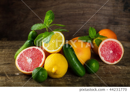 Raw fruit whole and cut on wooden background 44231770