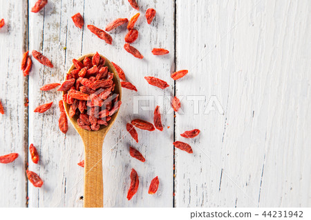 Dry goji berry on old white wooden background. Dry goji berry on old white wooden background. 44231942