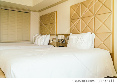 White comfortable pillow on bed decoration in hotel bedroom White comfortable pillow on bed decoration in hotel bedroom 44232511