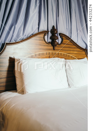 Beautiful comfortable white pillow on bed Beautiful comfortable white pillow on bed 44233274