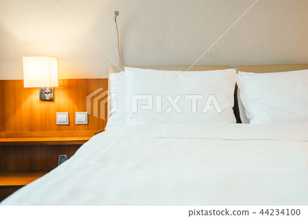 White pillow on bed decoration in bedroom interior White pillow on bed decoration in bedroom interior 44234100