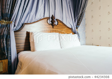 Beautiful comfortable white pillow on bed Beautiful comfortable white pillow on bed 44234308
