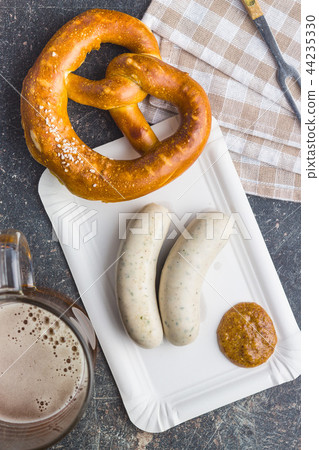 The bavarian weisswurst, pretzel and mustard. 44235330