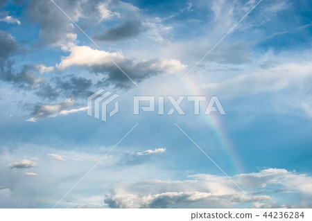 Arch rainbow natural phenomenon with clouds in sky 44236284