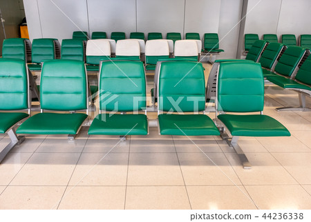 Rows of modern green chairs in waiting room 44236338