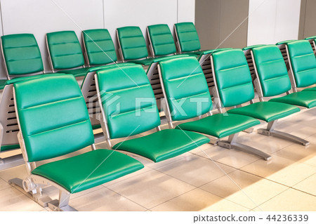 Rows of modern green chairs in waiting room Rows of modern green chairs in waiting room 44236339