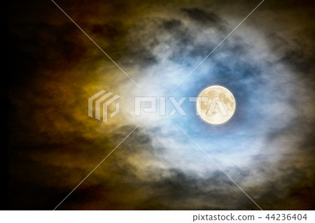 Full moon over dark cloudy sky Full moon over dark cloudy sky 44236404