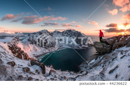 Man mountaineer standing on rock of peak Man mountaineer standing on rock of peak 44236622