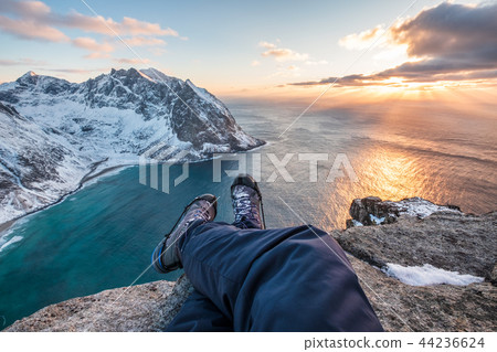Man hiker cross legs sitting on peak mountain 44236624
