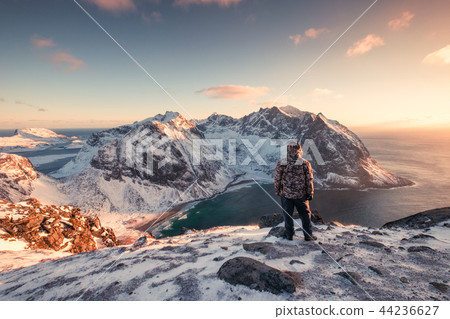 Man mountaineer standing on snowy mountain 44236627