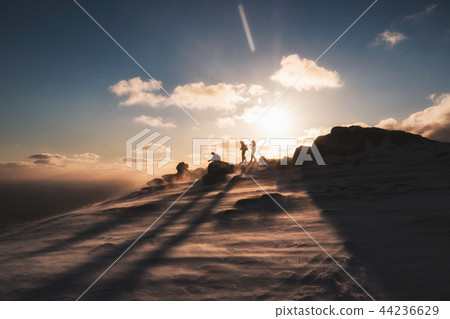 Climbers helping at on top mountain 44236629