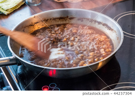 Wooden flipper chewing sweet sauce with garlic Wooden flipper chewing sweet sauce with garlic 44237304