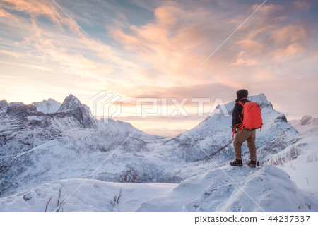 Tourist man climbs on top snowy mountain Tourist man climbs on top snowy mountain 44237337