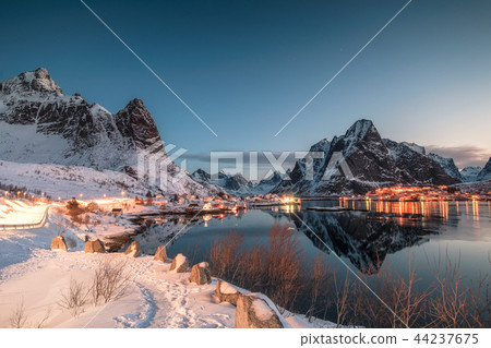 Fishing village illuminated in mountain valley 44237675