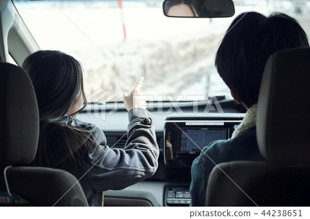 Men and women riding in cars 44238651