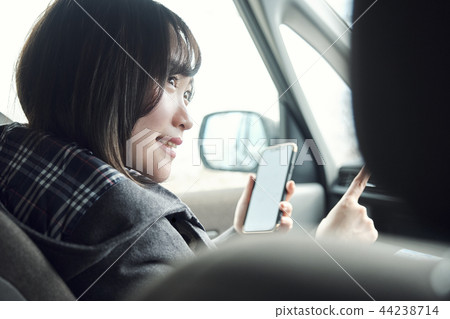 A woman riding a car A woman riding a car 44238714
