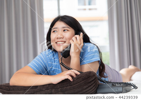 asian girl teen using calling landline telephone 44239339