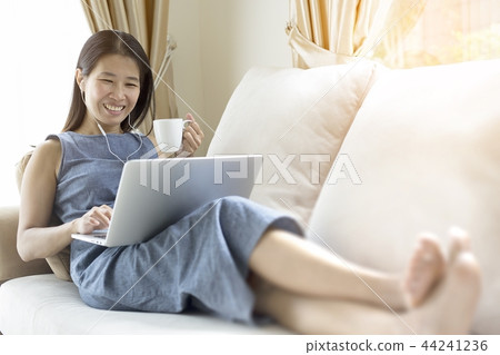She is working and is drinking coffee. She is working and is drinking coffee. 44241236