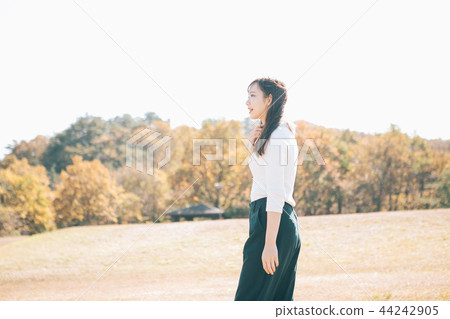 Autumn meadow and woman 44242905