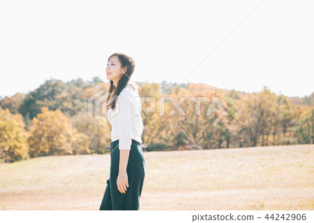 Autumn meadow and woman Autumn meadow and woman 44242906