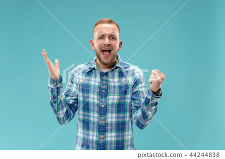 Beautiful male half-length portrait isolated on blue studio backgroud. 44244838