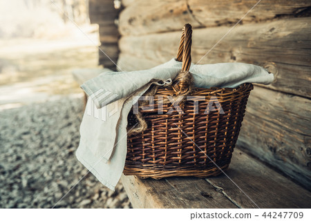 Basket with towel on the wooden bench in the village Basket with towel on the wooden bench in the village 44247709