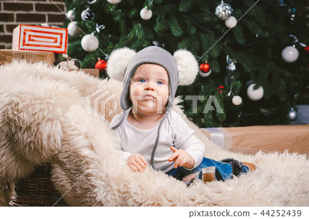 Subject children christmas new year. Caucasian little funny baby boy 1 year old sitting sleigh bear 44252439
