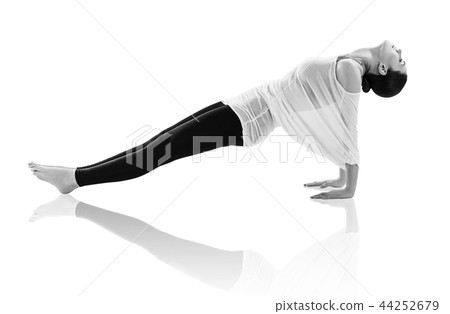 Young woman doing yoga exercise on the floor. 44252679